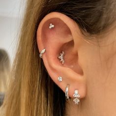 a close up of a person's ear with three different types of piercings