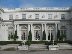 a large white building with many windows and statues