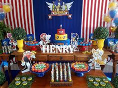 a table topped with lots of cakes and cupcakes