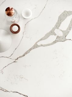 a white marble counter top with various items on it