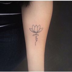 a woman's leg with a flower tattoo on the left side of her arm