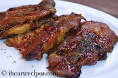 three pieces of meat on a white plate