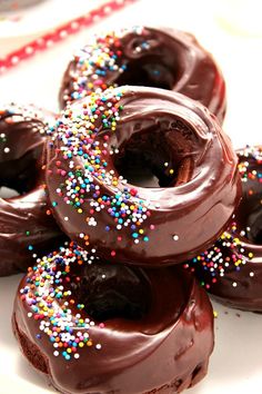 chocolate donuts with sprinkles on a plate