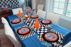 the table is set with racing themed plates and napkins