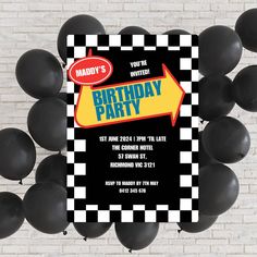 a birthday party with black and white checkerboard balloons in front of a brick wall