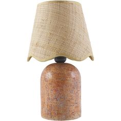 a lamp that is sitting on top of a wooden base with a fabric shade over it