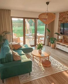 a living room filled with furniture and a flat screen tv on top of a wooden floor