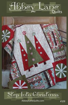 a quilted christmas tree on top of a bed with the words step into christmas