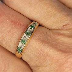 a close up of a person's hand with a wedding ring on their finger