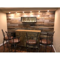 a bar with stools and barstools in front of a wooden paneled wall