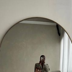 a woman taking a selfie in front of a mirror