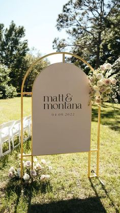 a sign that says mat and mountaina on it in front of some chairs with flowers