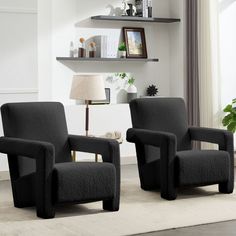 two black chairs sitting next to each other in a living room