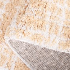 a close up view of a carpet with white and tan colors on it's surface