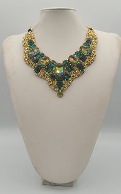 Each piece of our statement necklaces is handmade and one of a kind made in Italy. Our creations is made of high quality materials such as crystals and rhinestones. Each embroidered material is carefully hand sewn. Very glamorous and stylish. Perfect gift to someone you like. Materials Strass stone and Rhinestone in Emerald, Rainbow and Peridot  color in different dimension.  Black satin fabric backing. Aluminium chain with lobster closure. Measurements Weight approximate 200 grams. Chain lenght 25 cm - 9.84 in Circumference approximate 63 cm - 24.80 in Feel free to contact us if you have any question. Thank you so much for looking at our shop and our articles each of them, single piece. Handmade Costume Jewelry Choker For Party, Handmade Crystal Necklaces For Parties, Jeweled Choker Necklaces For Celebration, Unique Jeweled Necklace For Party, Luxury Handmade Beaded Necklaces For Party, Unique Necklaces With Jewels For Parties, Unique Long Beaded Necklaces For Parties, Handmade Luxury Beaded Necklace For Parties, Luxury Handmade Beaded Necklace For Party