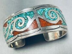 MAKE US AN OFFER BY CLICKING THE "MESSAGE SELLER" Button- We are proud to offer this remarkable vintage Navajo silver bracelet.  Beautiful wave designs of turquoise and coral chip inlay designs decorate the face of this remarkable cuff, as handstamped designs greet both sides.  The combination of vibrant turquoise and coral have really complemented each other well as they create the fabulous eye-catching design! Turquoise is highly valued and has a long-standing history in Native American jewelr Vintage Turquoise Bracelet With Inlay, Vintage Turquoise Bracelets With Inlay, Vintage Hand Tooled Turquoise Jewelry, Vintage Turquoise Bracelets With Hand Tooling, Vintage Turquoise Hand-tooled Bracelets, Turquoise Inlay Bracelet For Collectors, Native American Traditions, Navajo Bracelet, Turquoise And Coral