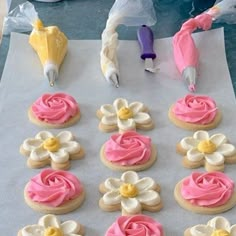 there are many decorated cookies on the table ready to be cut and put in the oven