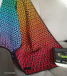 a colorful blanket sitting on top of a couch