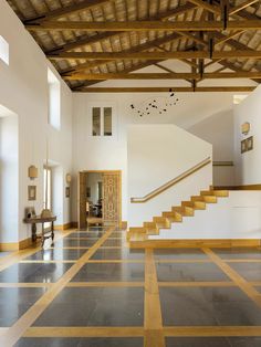 an empty room with stairs and tiled floors