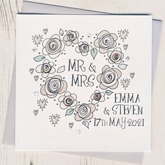 a wedding card with the words mr and mrs in a heart shape surrounded by flowers