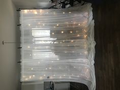 a white curtain with lights hanging from it