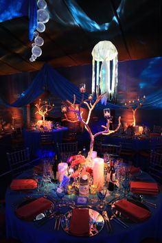 a table is set up with candles, plates and wine glasses for an elegant dinner