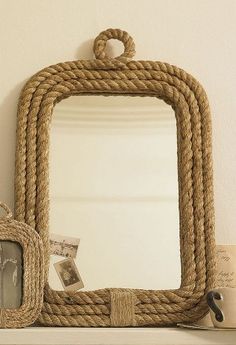 there is a mirror and some rope on the shelf