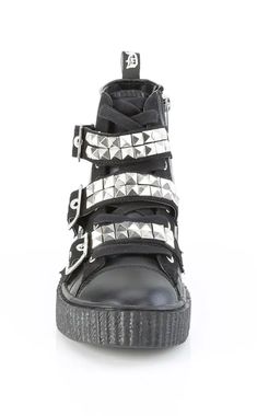 Half skate shoe, half wicked creeper. Demonia Sneekers are a comfy shoe with an edge. Black canvas vegan leather 1 1/2" 38mm platform Rubber sole Lace-up front High top Pyramid studded buckle straps Inner side zip closure U.S. Men's sizing, refer to size chart for more info. Punk Festival, Comfy Shoe, Demonia Boots, Demonia Shoes, Gothic Shoes, Skate Shoe, Shoes And Boots, Goth Punk, Comfy Shoes