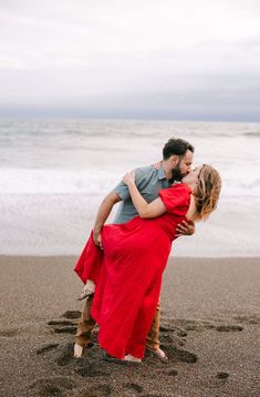 a man and woman hugging on the beach