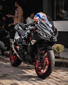 a black motorcycle parked on top of a brick road