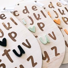 three wooden letters with hearts on them sitting next to each other