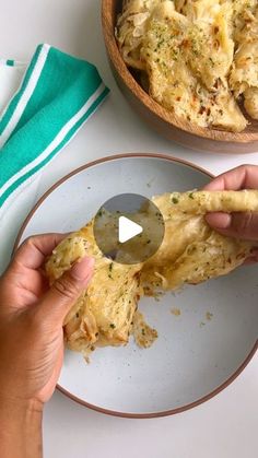 a person is holding a piece of food on a plate