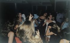 a group of people dancing at a party