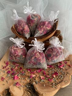 four bags of tea sitting on top of a wooden table