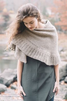 a woman wearing a knitted shawl in the fall