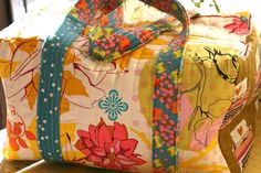 a colorful bag sitting on top of a wooden table