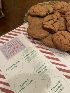 some cookies are sitting on a table next to a paper with stickers that says cookie strudel