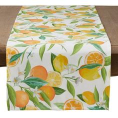 an orange print table runner on top of a wooden table