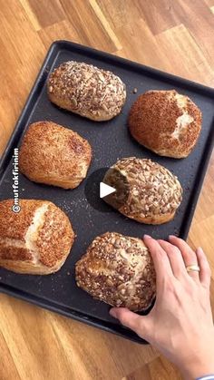 a person placing pastries on a baking tray