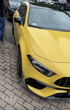 a yellow sports car is parked on the street