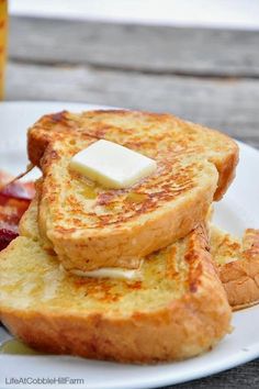 toasted french toast with butter and jelly on a white plate