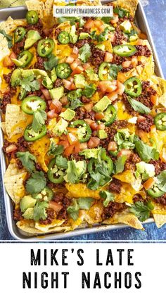 a tray filled with nachos covered in cheese and toppings