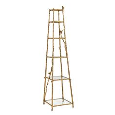 a tall gold bamboo shelf with glass shelves