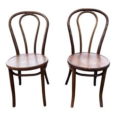 two wooden chairs side by side on a white background