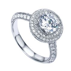 a white gold engagement ring with an oval center surrounded by round diamonds