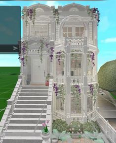 a large white house with purple flowers on the front and stairs leading up to it