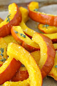 sliced oranges with herbs on them sitting on a table