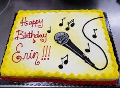 a sheet cake with a microphone and music notes on it that says happy birthday, ern