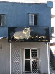 the entrance to a building that has been painted black and white with gold lettering on it