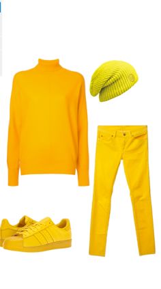 a yellow outfit is shown with sneakers and a beanie on the head, along with a pair of jeans